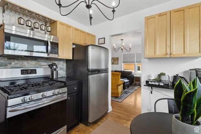 740 E Barrows Ave, Salt Lake City, UT 84106 - kitchen featuring stainless steel appliances, light brown cabinets, a chandelier, and light wood-style flooring