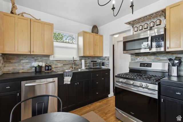 740 E Barrows Ave, Salt Lake City, UT 84106 - kitchen featuring stainless steel appliances, light brown cabinetry, a sink, and dark countertops