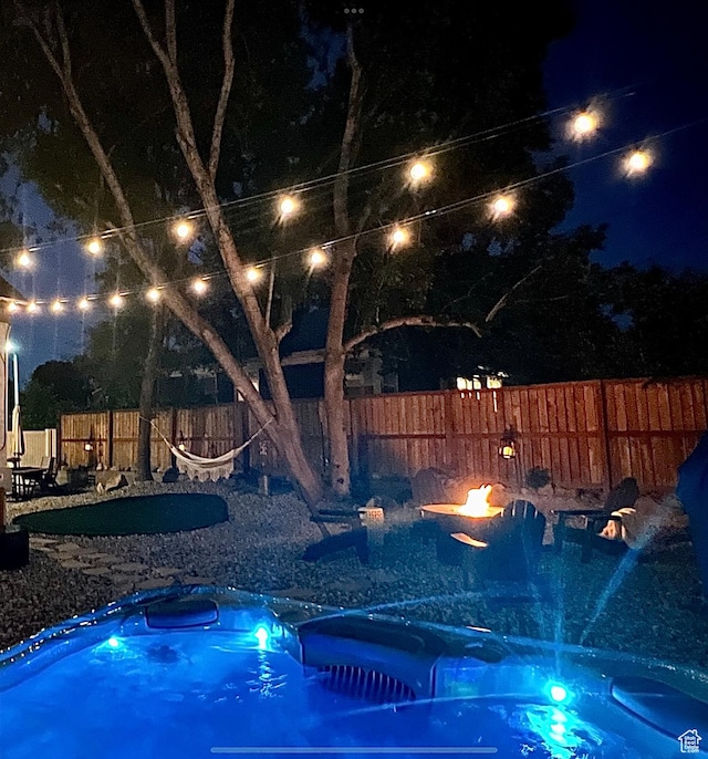 740 E Barrows Ave, Salt Lake City, UT 84106 - pool at night with a hot tub, a fenced backyard, and a fire pit