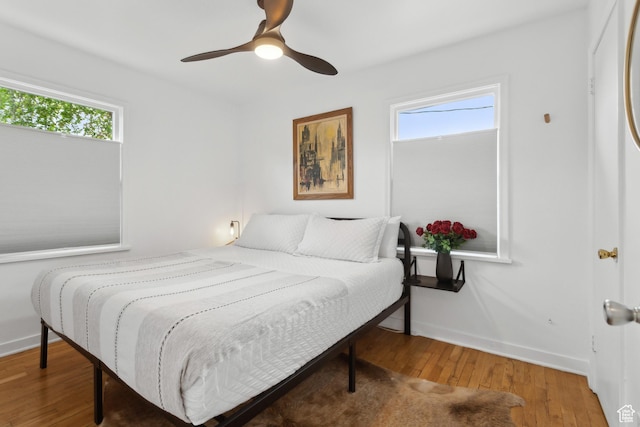740 E Barrows Ave, Salt Lake City, UT 84106 - bedroom with multiple windows, wood finished floors, baseboards, and a ceiling fan