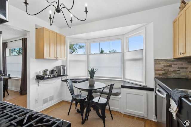740 E Barrows Ave, Salt Lake City, UT 84106 - kitchen with light wood-type flooring, light brown cabinets, a chandelier, and backsplash