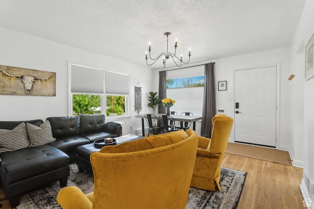 740 E Barrows Ave, Salt Lake City, UT 84106 - living room with a chandelier, wood finished floors, and a textured ceiling