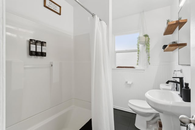 740 E Barrows Ave, Salt Lake City, UT 84106 - bathroom with tile patterned flooring, toilet, curtained shower, and a wainscoted wall