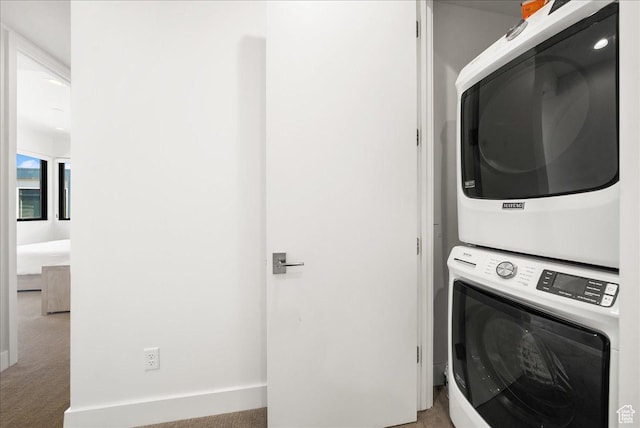 4134 Cooper Ln Unit 22, Park City, UT 84098 - clothes washing area featuring carpet flooring, stacked washer and dryer, and laundry area