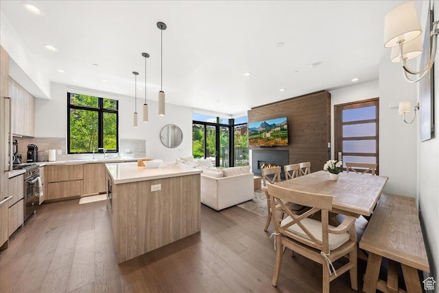 4134 Cooper Ln Unit 22, Park City, UT 84098 - kitchen with a center island, modern cabinets, light wood-type flooring, stainless steel range, and light brown cabinets