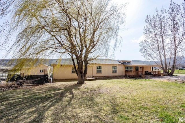 24517 W Rock Creek Rd, Duchesne, UT 84021 - back of property with a wooden deck and a yard