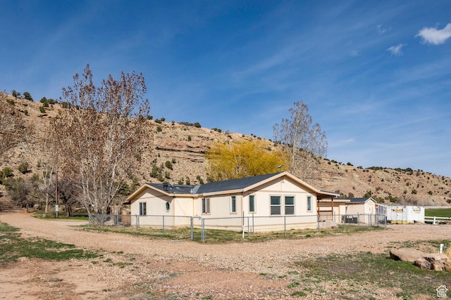 24517 W Rock Creek Rd, Duchesne, UT 84021 - view of side of home with a mountain view and fence private yard