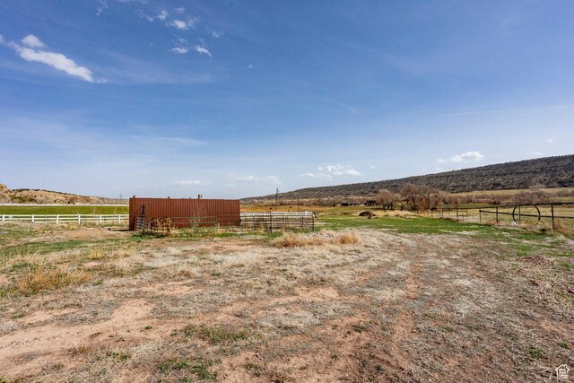 24517 W Rock Creek Rd, Duchesne, UT 84021 - view of yard featuring a pole building, fence, an outbuilding, and a rural view