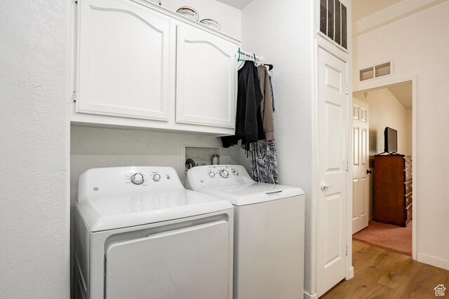 24517 W Rock Creek Rd, Duchesne, UT 84021 - laundry room with light wood-style flooring, independent washer and dryer, cabinet space, and visible vents