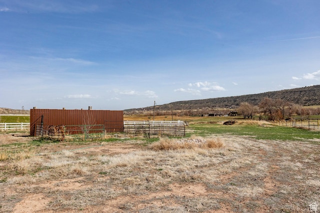 24517 W Rock Creek Rd, Duchesne, UT 84021 - view of yard featuring a rural view, fence, and an outdoor structure