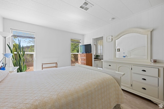 1526 N Dixie Downs Dr Unit 53, St George, UT 84770 - bedroom with access to outside, visible vents, and wood finished floors