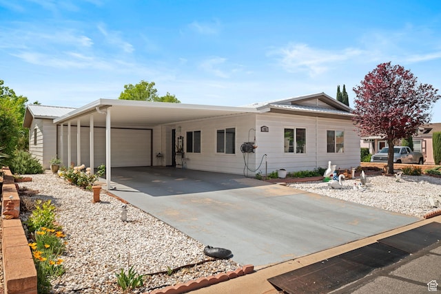 view of front of property featuring a garage, driveway, and a carport