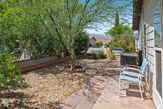 1526 N Dixie Downs Dr Unit 53, St George, UT 84770 - view of patio with a mountain view and fence