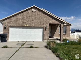 6267 S Waller Ln W, West Jordan, UT 84081 - single story home with brick siding, a garage, and driveway
