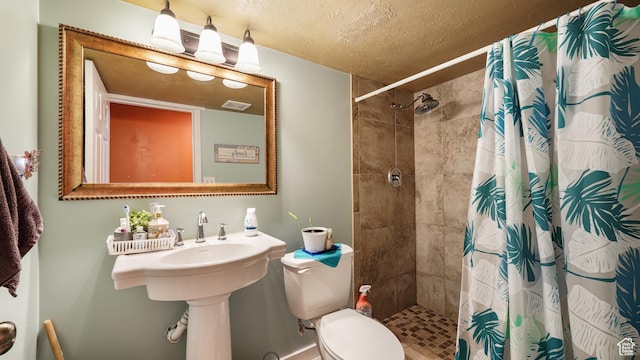 6267 S Waller Ln W, West Jordan, UT 84081 - bathroom featuring toilet, a tile shower, and a textured ceiling
