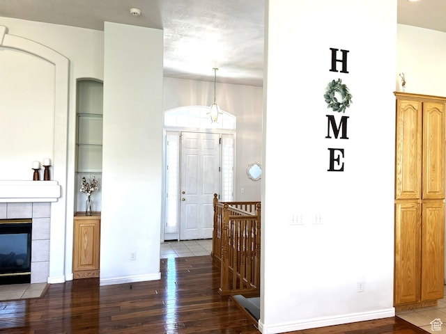 986 Davenport Dr S, Grantsville, UT 84029 - interior space with baseboards, hardwood / wood-style floors, a tiled fireplace, and built in features