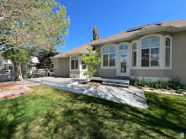 986 Davenport Dr S, Grantsville, UT 84029 - back of property featuring a yard, stucco siding, and solar panels