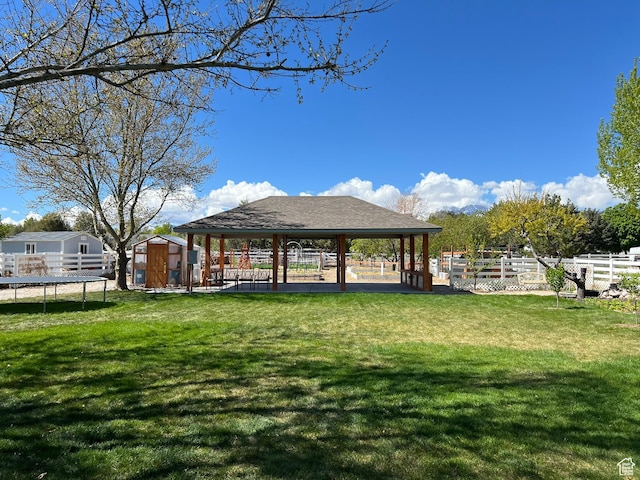 986 Davenport Dr S, Grantsville, UT 84029 - view of property's community featuring fence, an outdoor structure, a trampoline, a gazebo, and a storage unit