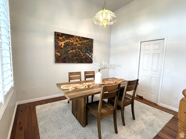 986 Davenport Dr S, Grantsville, UT 84029 - dining room featuring baseboards, a towering ceiling, and wood finished floors