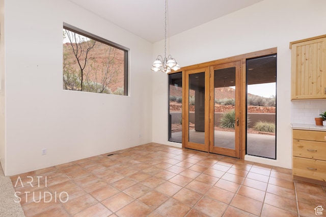 423 W Taman Ct, Ivins, UT 84738 - unfurnished dining area featuring french doors and a chandelier