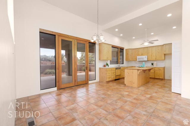 423 W Taman Ct, Ivins, UT 84738 - kitchen with light countertops, light brown cabinets, white microwave, and a kitchen island