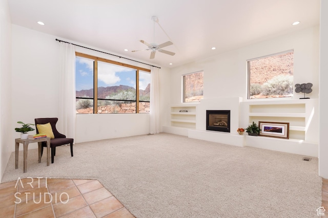 423 W Taman Ct, Ivins, UT 84738 - unfurnished living room with recessed lighting, carpet flooring, a glass covered fireplace, and ceiling fan
