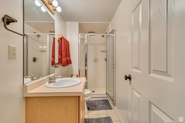 1253 Oakridge Ln, Bountiful, UT 84010 - bathroom with tile patterned flooring, vanity, a shower stall, and toilet