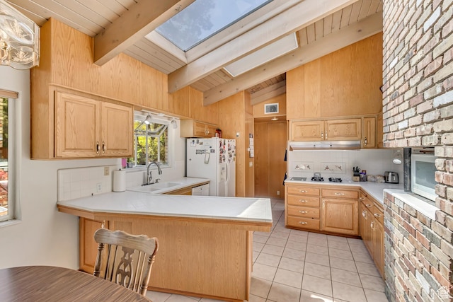 1253 Oakridge Ln, Bountiful, UT 84010 - kitchen with white appliances, a skylight, a sink, tasteful backsplash, and a peninsula