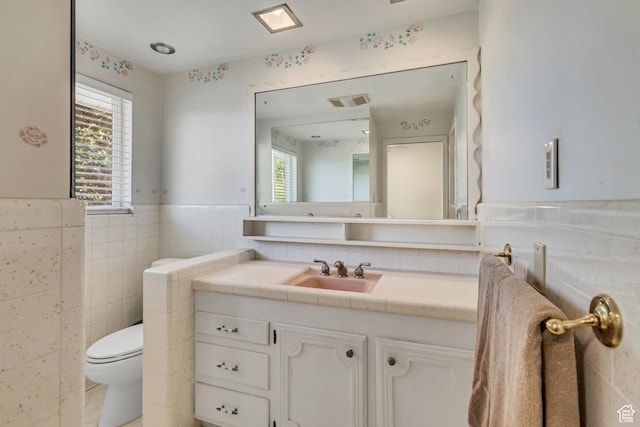 1253 Oakridge Ln, Bountiful, UT 84010 - bathroom featuring tile walls, vanity, toilet, and a wainscoted wall