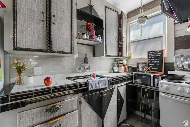 827 E 100 S, Salt Lake City, UT 84102 - kitchen featuring stainless steel microwave, backsplash, white gas stove, and extractor fan