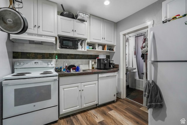 827 E 100 S, Salt Lake City, UT 84102 - kitchen featuring dark countertops, a sink, white appliances, under cabinet range hood, and dark wood-style floors