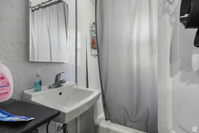 827 E 100 S, Salt Lake City, UT 84102 - bathroom featuring a textured wall, shower / bathtub combination with curtain, and a sink
