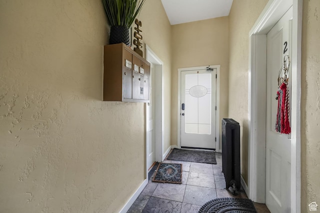 827 E 100 S, Salt Lake City, UT 84102 - doorway to outside featuring stone tile floors, baseboards, and a textured wall