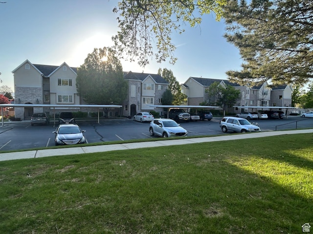 partially covered parking lot featuring a residential view