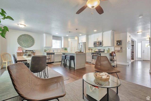 494 N 300 E, American Fork, UT 84003 - living room featuring a textured ceiling, a ceiling fan, recessed lighting, and wood finished floors