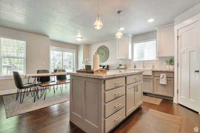 494 N 300 E, American Fork, UT 84003 - kitchen with a kitchen island, dark wood-style flooring, hanging light fixtures, gray cabinetry, and a sink