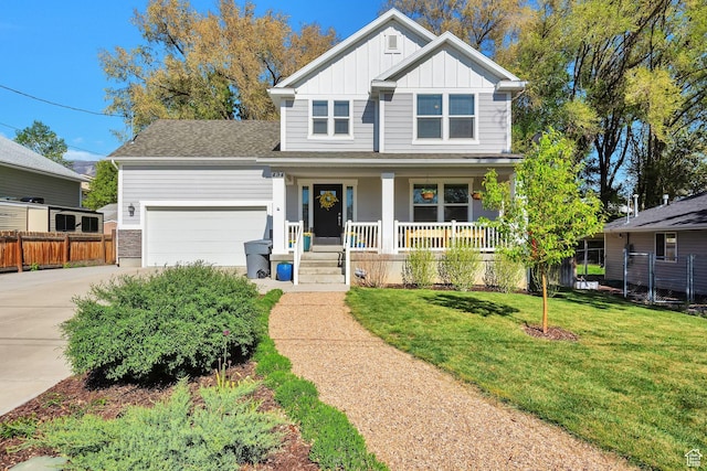 494 N 300 E, American Fork, UT 84003 - view of front facade with covered porch, board and batten siding, driveway, a front lawn, and an attached garage