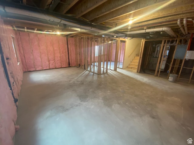 unfinished basement featuring stairway