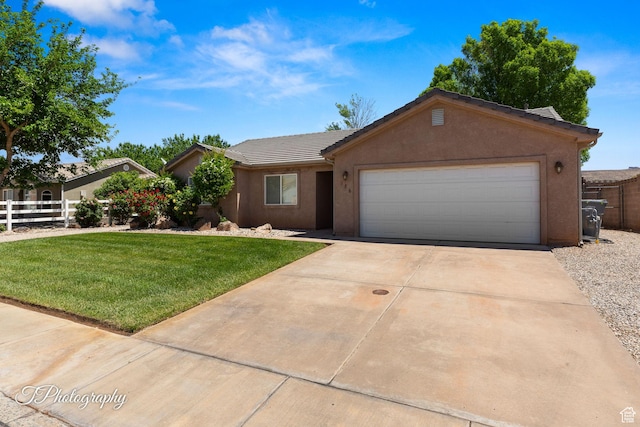 186 N 870 W, Hurricane, UT 84737 - ranch-style home featuring fence, an attached garage, a front lawn, stucco siding, and driveway