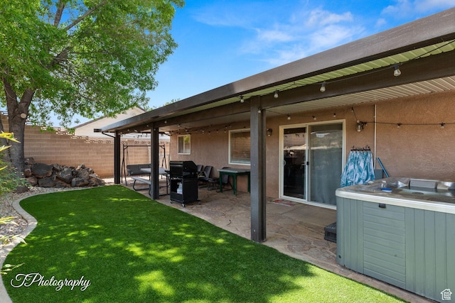 186 N 870 W, Hurricane, UT 84737 - exterior space featuring a lawn, a hot tub, fence, a patio, and stucco siding