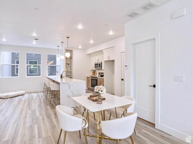 365 W 800 N Unit 3, Salt Lake City, UT 84103 - dining area featuring baseboards, visible vents, and light wood-style floors