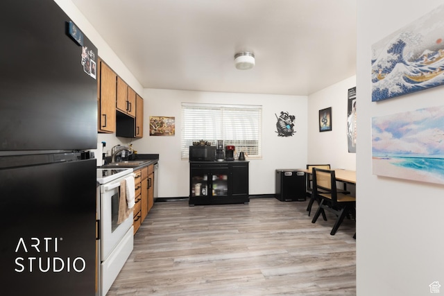 257 W 600 N, Lehi, UT 84043 - kitchen featuring dark countertops, a sink, light wood-style floors, brown cabinetry, and black appliances