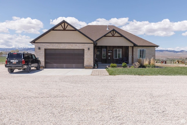 10360 S 10750 W, Axtell, UT 84621 - view of front of property featuring stone siding, a garage, stucco siding, a porch, and concrete driveway