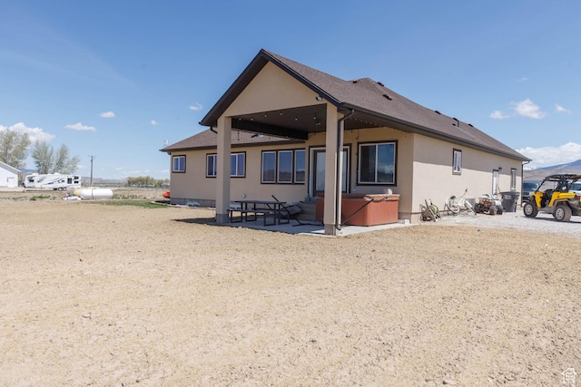 10360 S 10750 W, Axtell, UT 84621 - rear view of property featuring a patio, a hot tub, and stucco siding