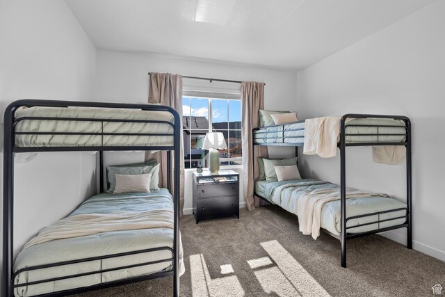 carpeted bedroom featuring baseboards