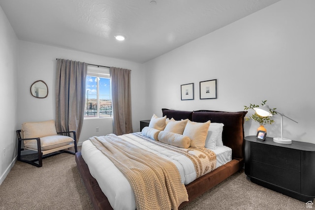 carpeted bedroom featuring baseboards and recessed lighting