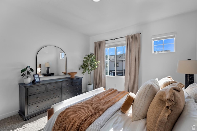 carpeted bedroom with baseboards and multiple windows