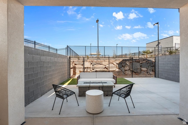 view of patio featuring a fenced backyard and an outdoor living space with a fire pit