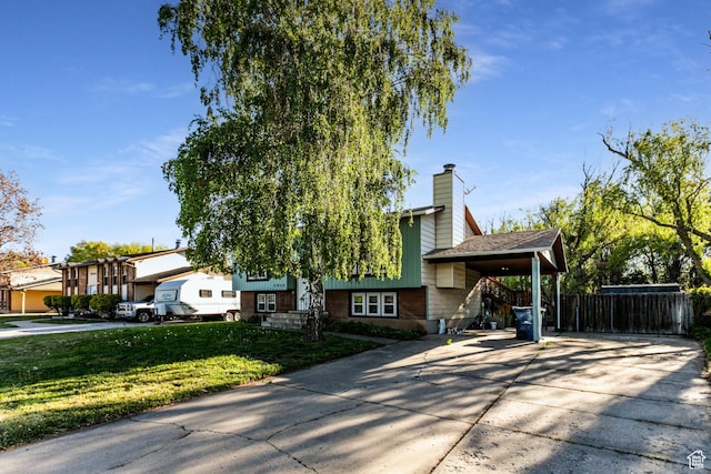 5952 S 2550 W, Roy, UT 84067 - view of front facade featuring fence, a chimney, concrete driveway, and a front yard