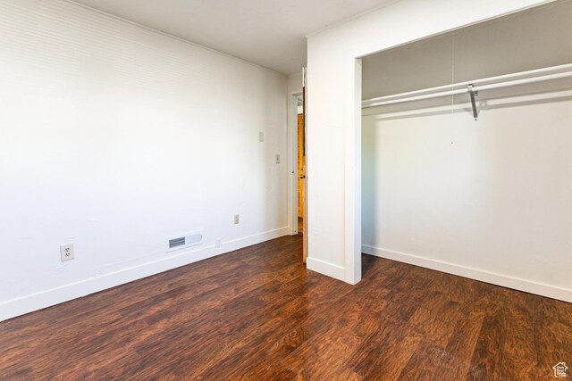 5952 S 2550 W, Roy, UT 84067 - unfurnished bedroom with baseboards, a closet, wood finished floors, and visible vents